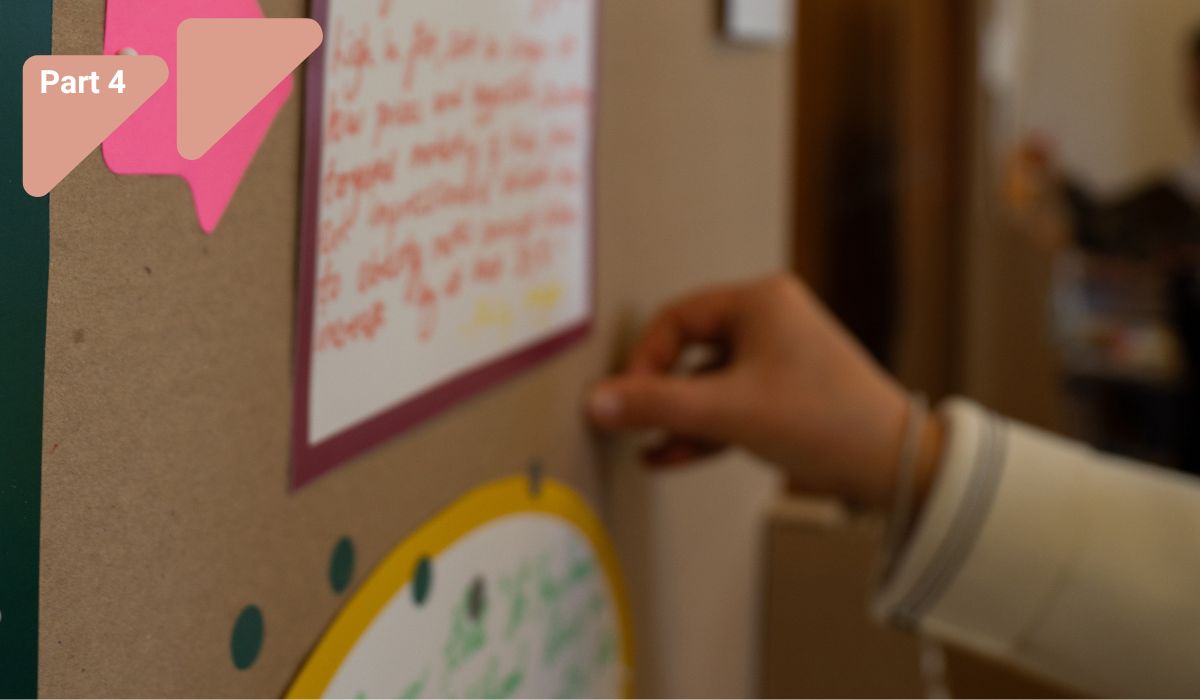 Person pinning a note on a board