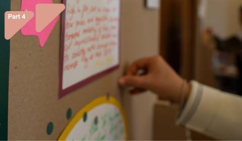 Person pinning a note on a board