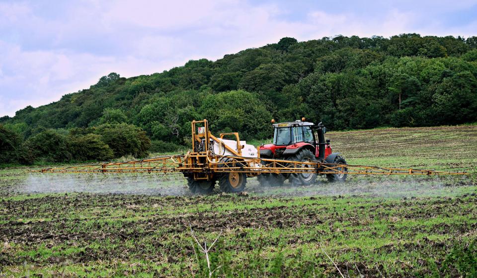Tractor with pesticides working in agriculture 